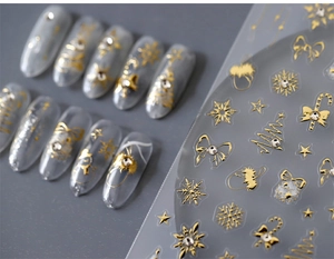 Detail of luxury gold Christmas nail stickers featuring snowflakes and mini rhinestones