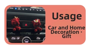 Detail of red bear car air vent clips with gold crown and wings on car dashboard