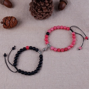 Detail showing magnetic heart clasp joining black and pink stone bead bracelets