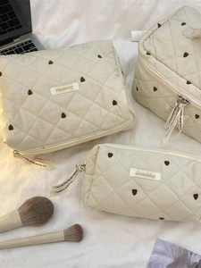 Beige quilted heart pattern makeup bags in three sizes for travel and stationery storage
