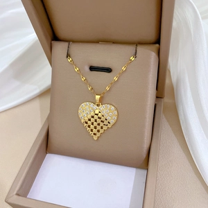 Elegant gold hollow heart necklace with crystals in a beige jewelry gift box