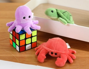 Close-up of cute plush sea animal finger puppets including purple octopus and green turtle