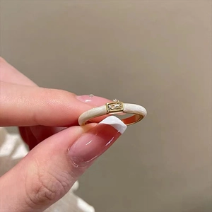 Detailed macro view of gold-plated butterfly ring featuring a rectangular zircon stone