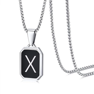 Detail of silver box chain with black octagonal pendant featuring a silver letter X