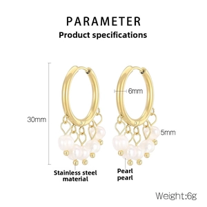 Detail view of 30mm gold stainless steel hoop earrings with five white hanging pearls