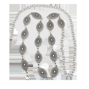 Detailed view of vintage silver metal waist chain with embossed sunburst oval plaques