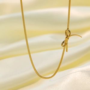 Elegant gold bow snake chain necklace for women made of 18K gold plated titanium steel