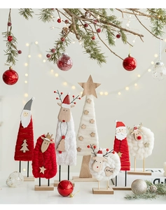 Detail of wool felt Santa and reindeer Christmas ornaments on solid wood bases