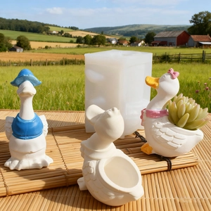 DIY duck candle holder silicone mold and finished succulent planters in outdoor setting