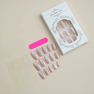 Complete press-on nail kit with champagne glitter nails and tools in a branded gift box