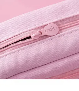 Close-up of pink canvas pencil case showing premium teardrop zipper with moko engraving