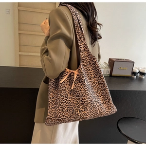 Detail of leopard print tote bag with side ribbon bow knot and wide shoulder strap