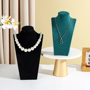Detail of luxury velvet mannequin stand and jewelry display with elegant necklaces