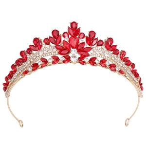 Detail of gold bridal crown with sparkling red rhinestones and clear crystals