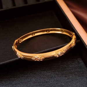 Detailed macro of vintage gold flower buckle bracelet with crystals in a jewelry box