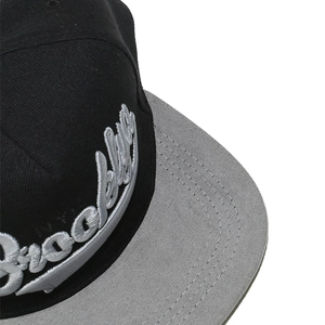 Close-up of 3D Brooklyn embroidery and multi-stitch detail on a flat brim baseball cap