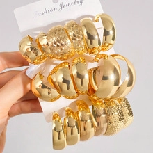 Detailed view of 9-piece gold hoop earring set with various textures and sizes on card