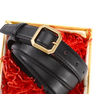 Women's black leather skinny belt with a gold hexagonal buckle inside a gift box