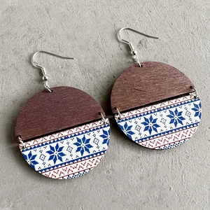 Bohemian round earrings with blue snowflake pattern and wood texture on stone background