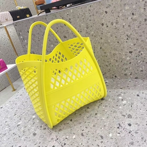 Detailed view of the bright yellow hollowed-out silicone tote bag for beach and shopping