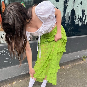 Summer outfit featuring white puff sleeve crop top and green layered lace maxi skirt