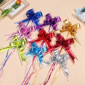 Close-up of matte metallic gift bows in multiple colors for festive packaging and decor