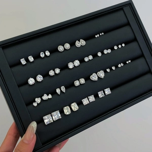 Macro shot of assorted geometric cubic zirconia stud earrings in a jewelry box