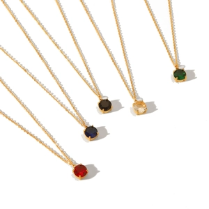 Golden stainless steel necklaces with five colored round gemstone pendants on white background