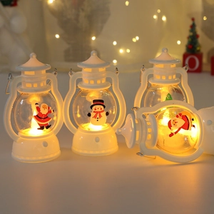Close-up of four white vintage Christmas LED lanterns with warm glowing festive patterns
