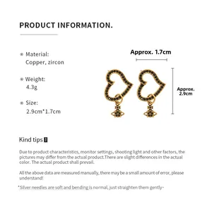 Detail showing dimensions of heart and planet earrings with copper and zircon material