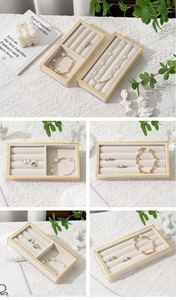 Close-up of velvet jewelry display tray with gold trim and specialized ring compartments