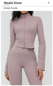 Detail of greyish purple yoga jacket with stand collar, zipper, and thumbhole cuffs