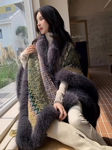 Detail of fox fur collar on a bohemian geometric knit poncho with colorful patterns