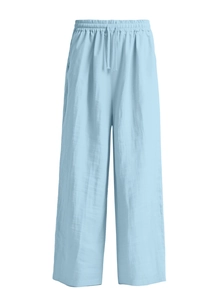Detail of light blue cotton linen trousers with elastic drawstring waistband and texture