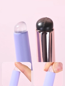 Macro detail of portable silicone lip brush showing soft bouncy texture and dual-head design
