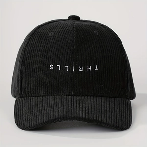 Macro shot of white inverted THRILLS embroidery on premium black corduroy baseball cap