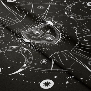 Detailed macro view of celestial sun and moon prints on textured black fabric tapestry