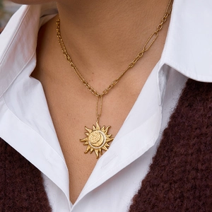 Luxurious gold sun and moon pendant necklace set in stainless steel on a model