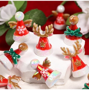 Macro shot of miniature Christmas reindeer and angel beads on a white decorative stone