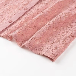 Pink floral lace polo shirt with delicate buttons and intricate layered textures