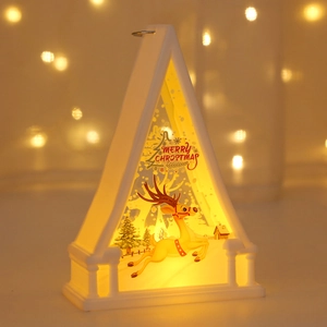 Close-up of a white LED Christmas lantern featuring a reindeer pattern and warm light