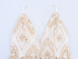 Detail of bohemian cream v-neck top with light brown geometric embroidery and cross straps