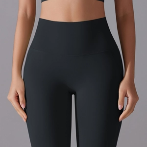 Detail of high-waist black yoga leggings featuring seamless belly control and a lift effect