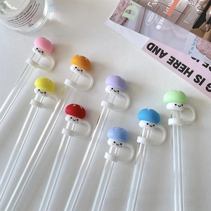 Close-up of eight colorful mushroom-shaped silicone straw covers with cute smiley faces