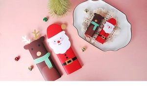 Christmas gift cards featuring cartoon Santa and reindeer designs on a white plate
