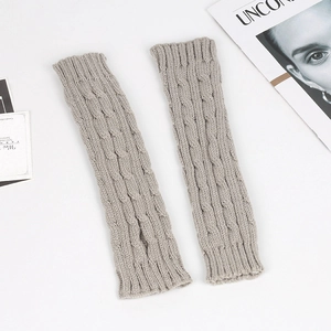 Close-up of grey cable-knit long fingerless gloves in a stylish flat lay photography