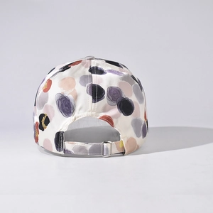 Rear view of polka dot baseball cap with adjustable silver metal buckle on back