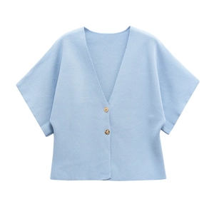 Close-up of light blue ribbed knit cardigan featuring textured fabric and gold buttons