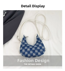 Close-up of blue and white checkered crescent bag with fringe edge and silver zipper