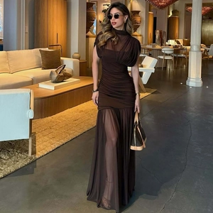 Close-up of elegant dark brown maxi dress featuring sheer mesh panels and pleated textures